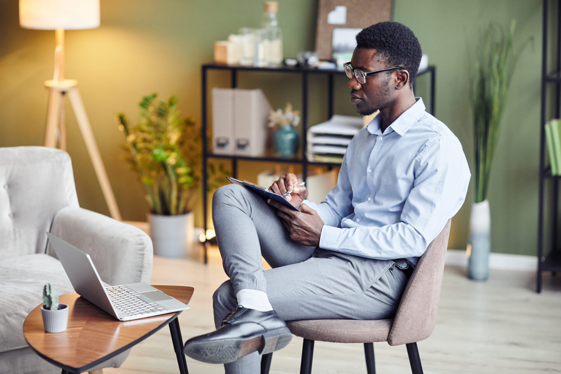 a psychologist taking notes during a therapy session