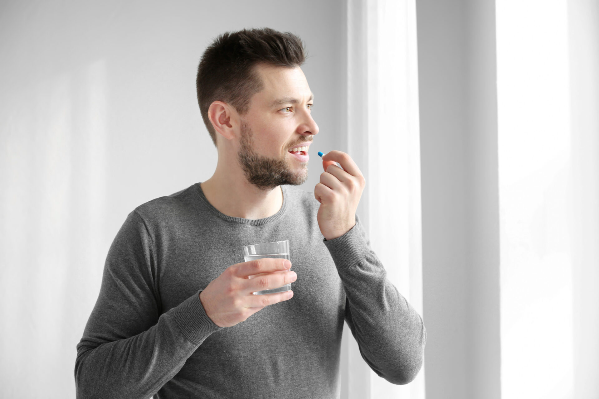 young man taking medication for mental health
