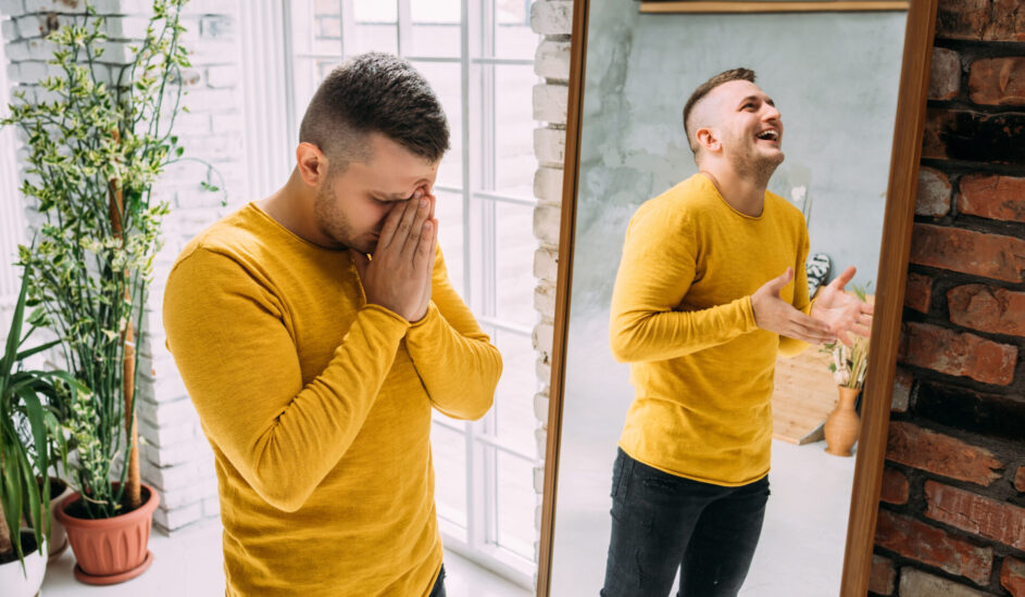 An image of a man evoking seeing a different reflection in the mirror, evoking a personality disorder.